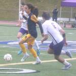 Spartan Blake Moyer dribbles the ball past defenders in a Bainbridge district championship win over North Kitsap May 17 at Olympic High School.