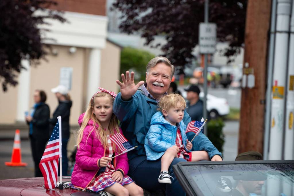 Bremerton Mayor Greg Wheeler, a Navy veteran, waves to the crowd during the Armed Forces Day Parade May 17.