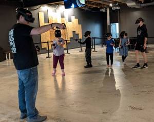 Sean Ong courtesy photos 
Campers wear VR headsets and travel as a group to explore topics like the solar system, atoms and molecules, and natural environments.