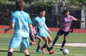 Luke Caputo/Kitsap News Group photos
Port Orchard FC midfielder Jaggar Judkins keeps the ball away from an incoming defender in a 4-1 win against Sharktopus FC June 7 at Kitsap Bank Stadium in Port Orchard.