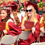 Kingston graduates show off their diplomas.