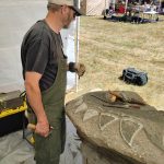 Shane Jewell of Olympia carves a dragon from siltstone with hammer and chisel.