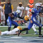 Luke Caputo/Kitsap News Group photos
Olympic running back Chace Webster stiff-arms an Aberdeen defender in a 27-25 Trojan loss to the Bobcats Sep. 5 at Integrity Roofing Stadium.