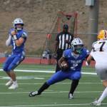 Trojan QB Toby Moore executes a draw play with Chace Webster running the ball in a loss to Aberdeen Sep. 5.