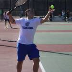 Trojan Killian Shirk tosses a ball up to serve in a match against Central Kitsap Sept. 15.