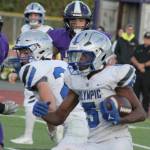 Trojan DArre Bell runs the ball with Viking defensive-lineman Paul Bermudez in pursuit in a 27-14 Olympic win over NK Sept. 18.