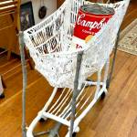 David Lewis Mobile Home Soup Kitchen is made with a shopping cart sculpture mounted on the base of an old baby carriage and filled with a painted Campbells soup bag.