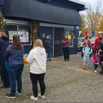 Community members line up to receive turkeys and grocery bags for Thanksgiving.