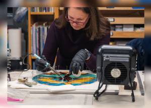 A student works in BARNs Glass Arts Studio during Copper Foil Stained Glass, taught by Diane Bonciolini of Mesolini Glass. Courtesy BARN