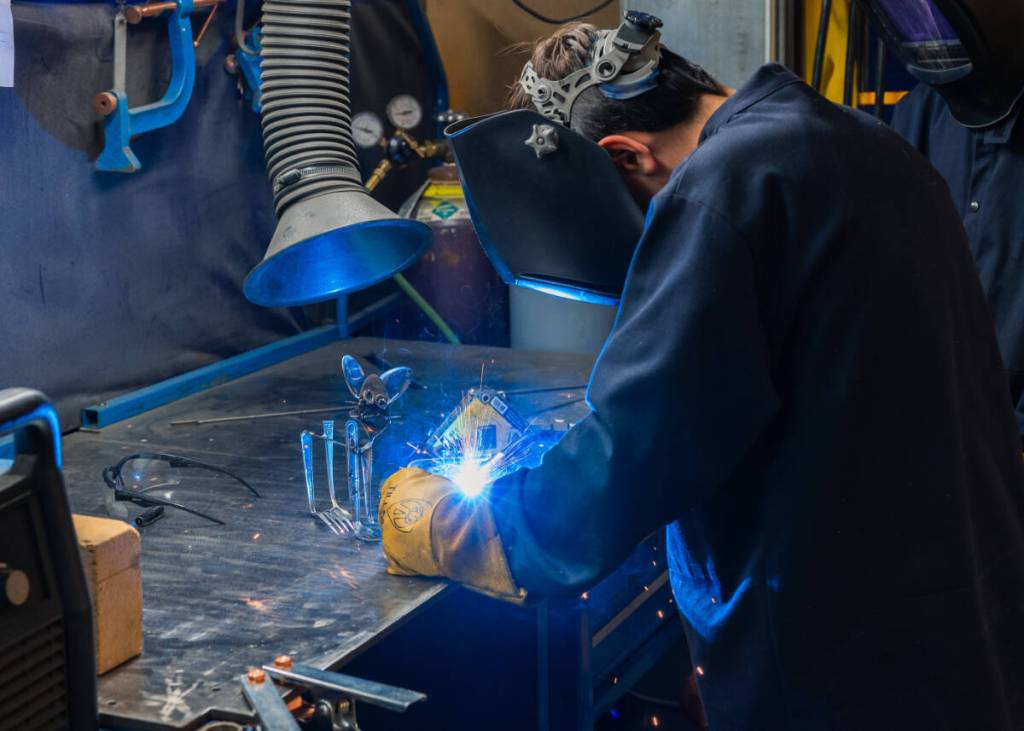 A young metalworker welds during a Youth: Weld a Metal Pet class at BARN. Courtesy BARN