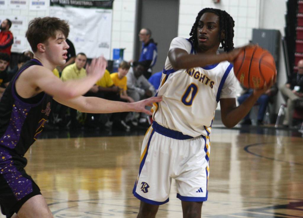 Knight Enoch Taylor looks to make a pass in a 55-54 Bremerton win over Columbia River March 6 in the semifinals of the 2A boys state basketball tournament at the Yakima SunDome.