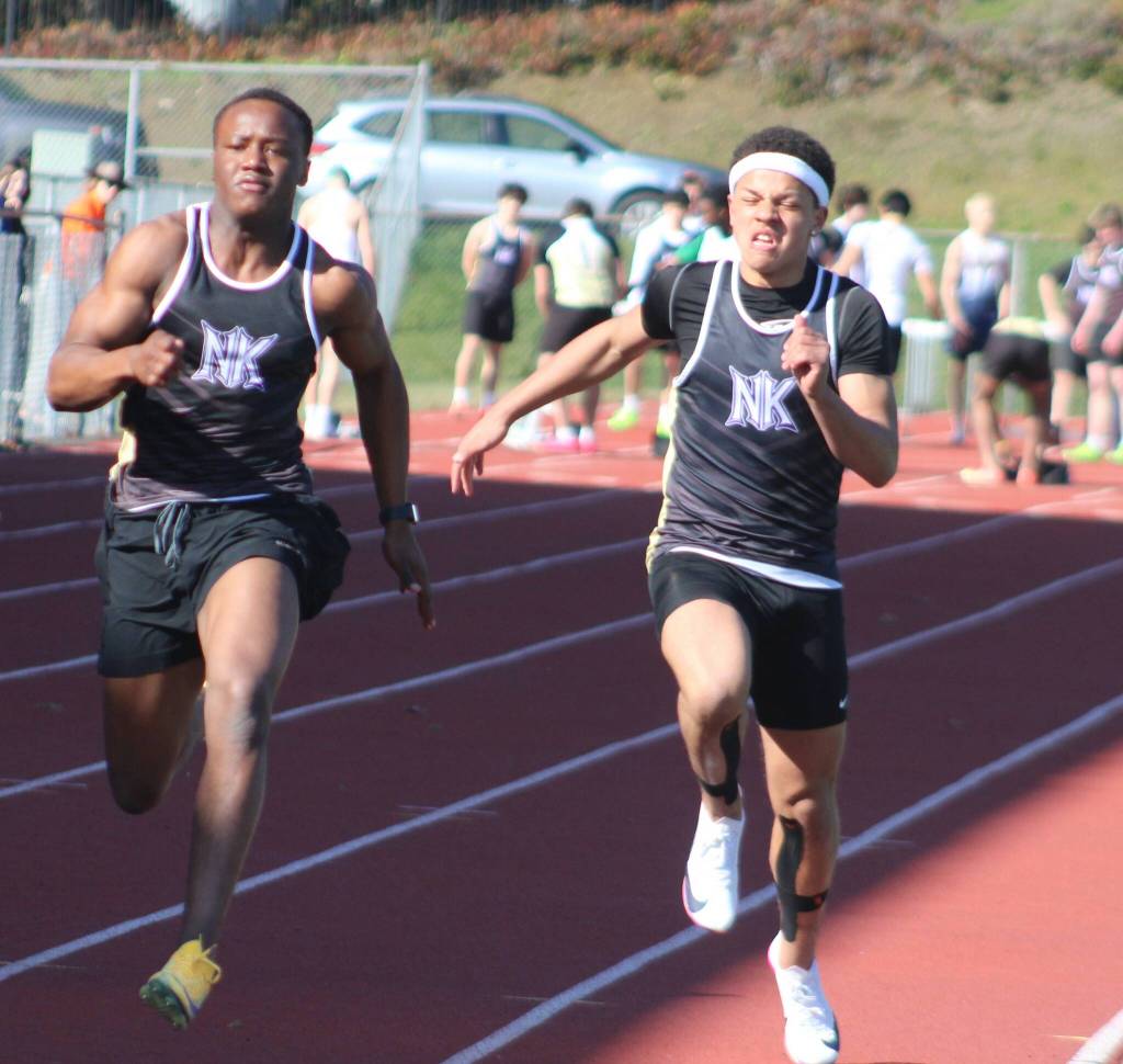 Vikings Isaiah Randall (left) and Ellis Slade (right) sprinting in the boys 100-meters during a track and field meet at North Kitsap High School March 26.