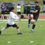 Viking Mason Peters keeps the ball away from an incoming Bulldogs defender in NKs 2-0 win over North Mason in the first round of the 2026 District 3 2A Boys Soccer Tournament May 9 in Poulsbo.